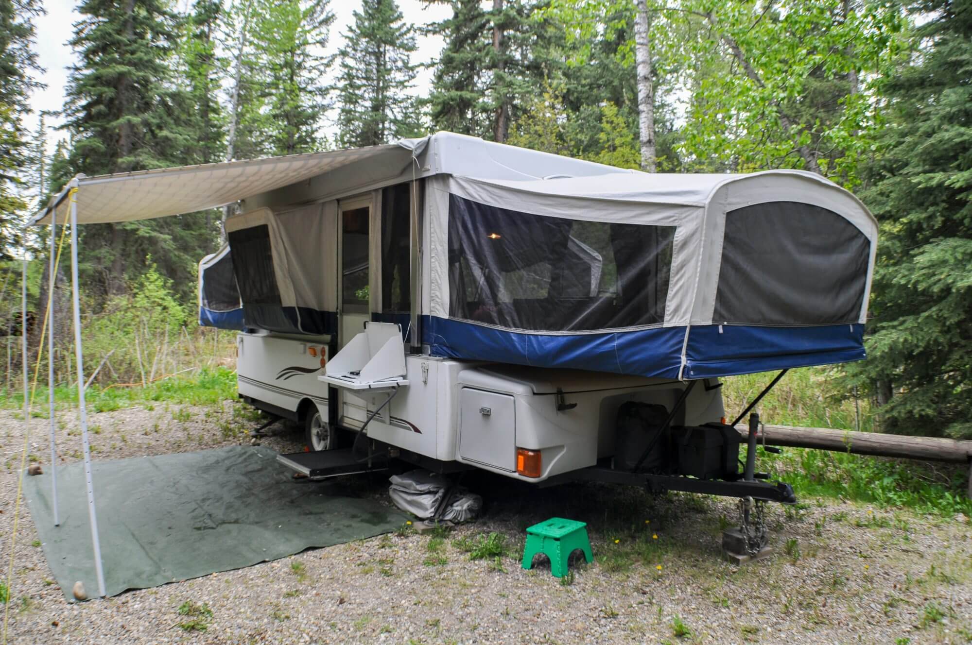 Tent trailer set up in Wooded Campground