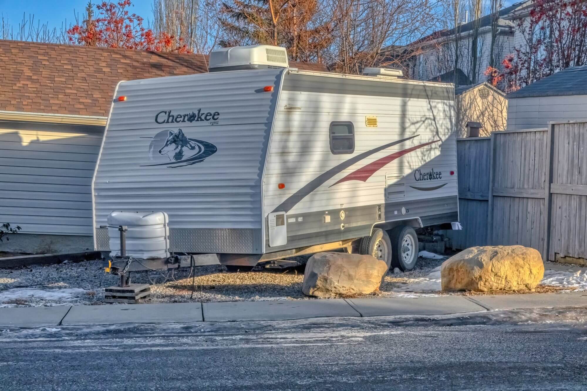 Calgary, Alberta, Canada. Jan 25, 2023. An RV toy haulers trailer parked in front a house during winter. Concept: recreational vehicle