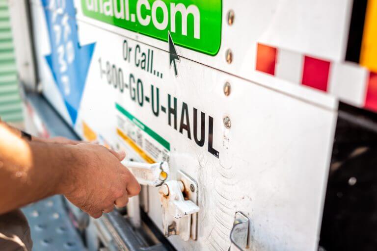 Ft Myers, USA - May 16, 2022: Closeup of man hand locking closing door of U-haul cargo truck trailer vehicle for move, moving relocation from Florida