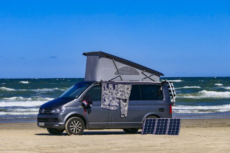 Lokken, Denmark, Aug 6, 2020 A camping van on the beach with solar panels.