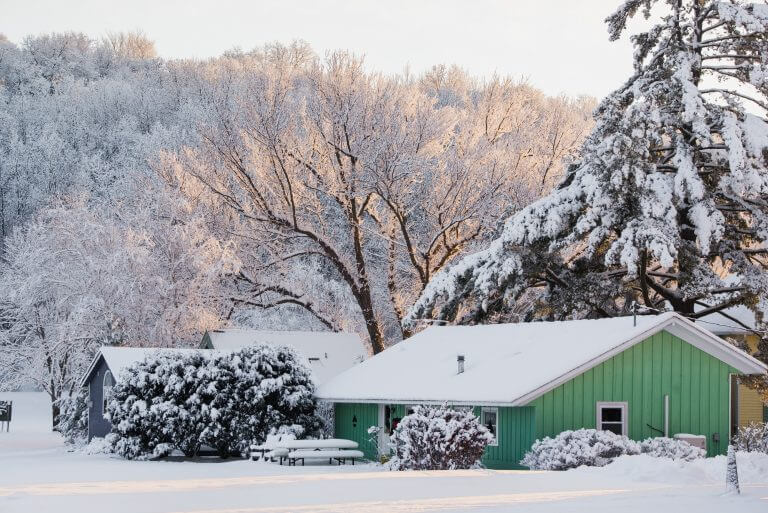 A calm early winter morning in Wisconsin with a green house