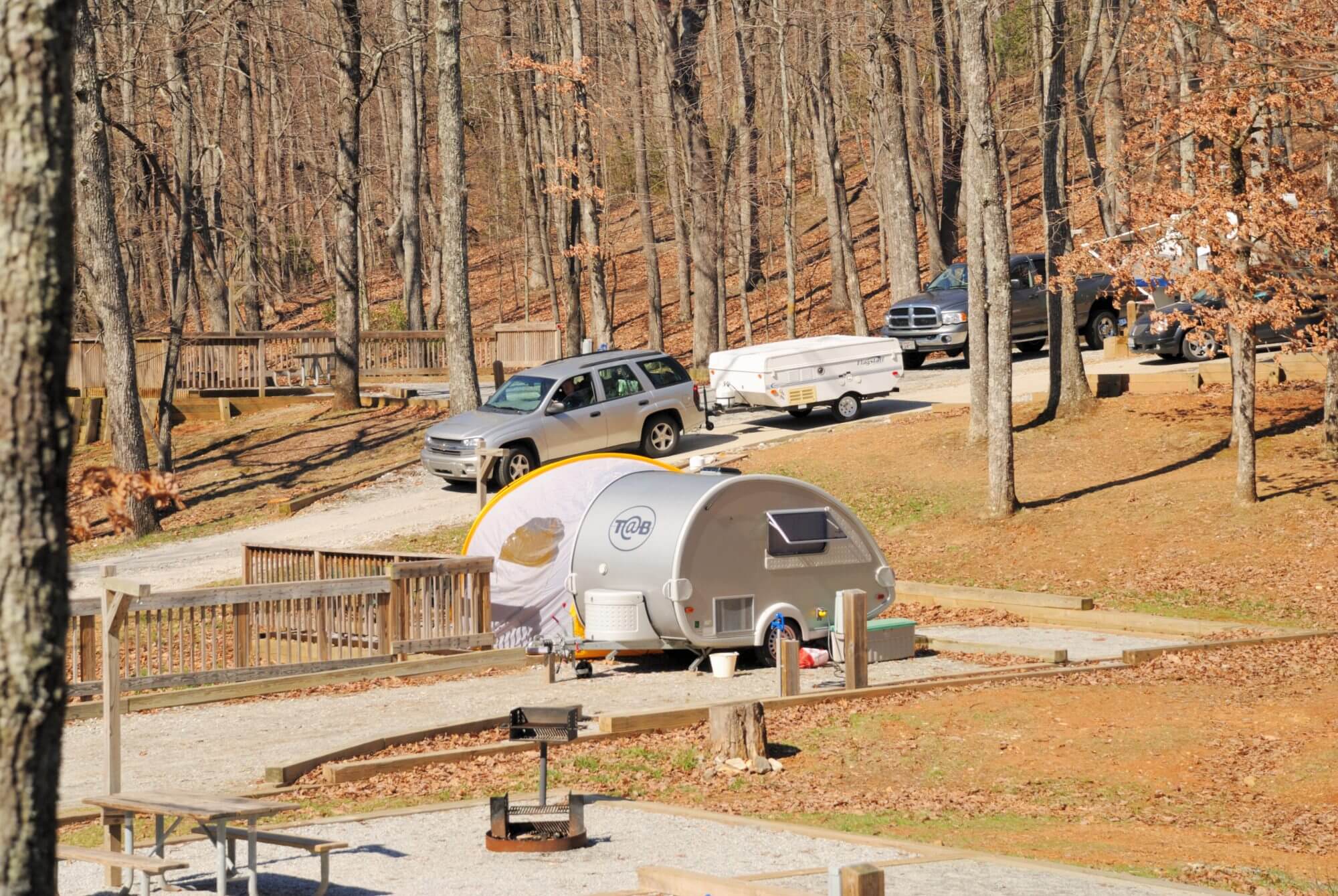 Amicalola Falls State Park, Georgia, USA - March 16, 2008: RVs and trailers in Amicalola Falls State park in north central Georgia. Teardrop shaped rv in front with suv and popup driving down hill.