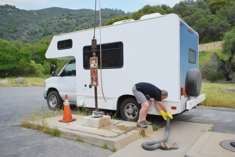Man with  RV vehicle in dumping station