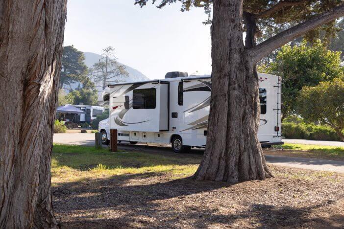 Camping in motor home in State Park campground. C class, cab over motor home with slide outs. Clamping. No People.