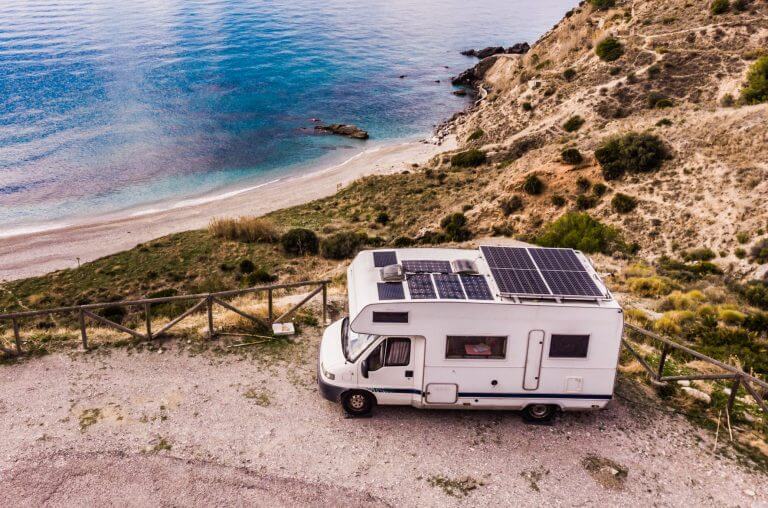 Caravan with solar panels on roof camping on cliff sea coast. Mediterranean region of Nerja, Costa del Sol in Andalusia, Spain.