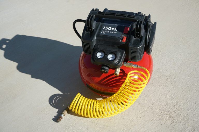A portable electric air compressor with coiled hose.