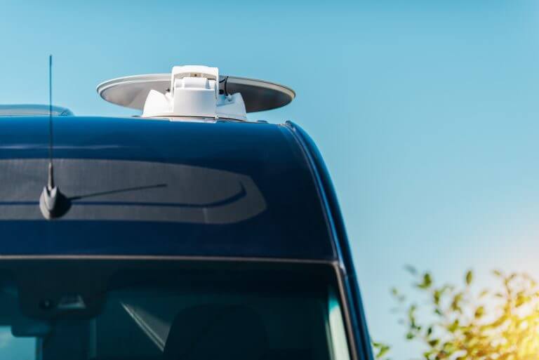 RV Camper Satellite TV Dish Installed on the Roof. Mobile TV Equipment.