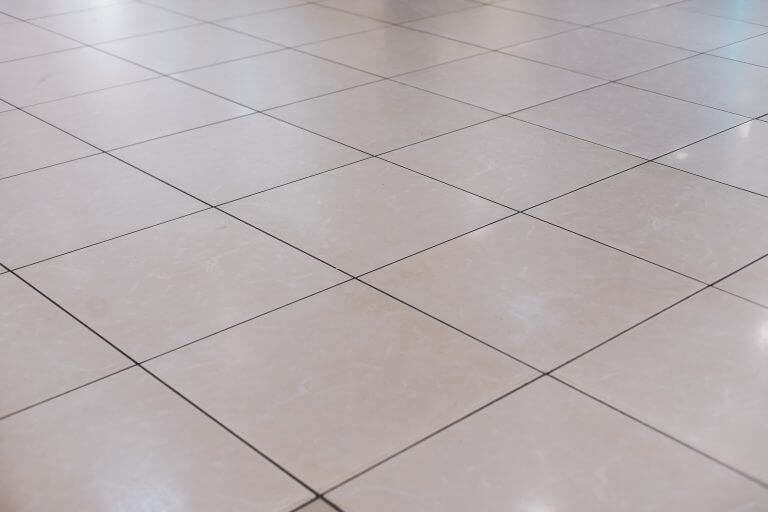 Beige tile on the floor in perspective