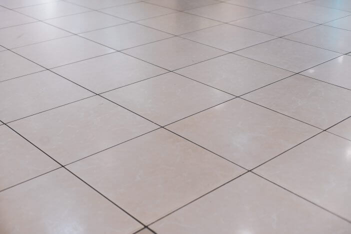 Beige tile on the floor in perspective