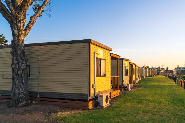 Moonta Bay, South Australia - October 26, 2019: Moonta Bay caravan park accomodation cabins in a line at sunset, South Australia