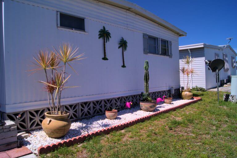 Mobile Home landcaping in Fort Myers, Florida, USA. Includes palm trees, cactus and pink flamingos.