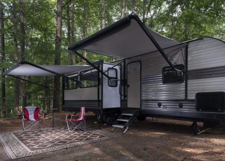 Camper trailer set up with awnings out at a campsite at Jordan Lake