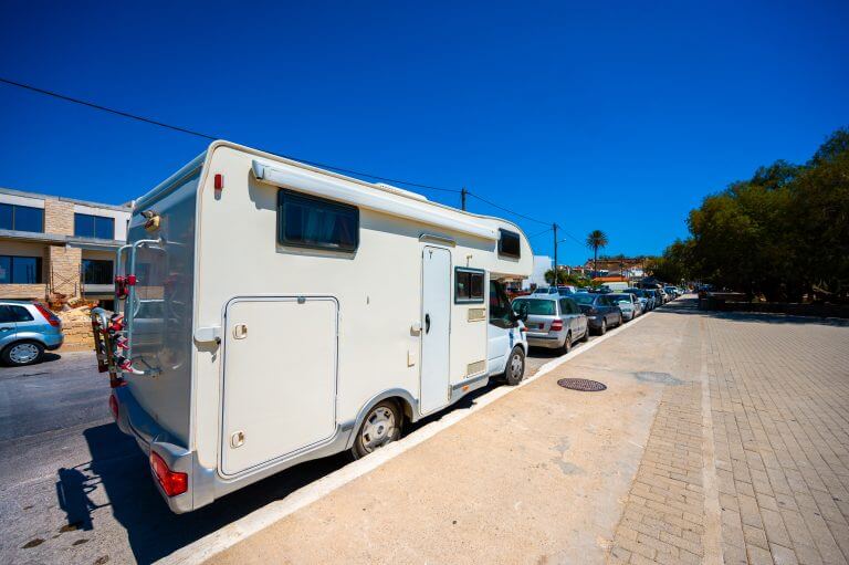 Motorhome  parked in public parking on the street in Paleochora. Campervan or motorhome is parked on the roadside in the Greek village and beach of Paleochora, Crete, Greece.