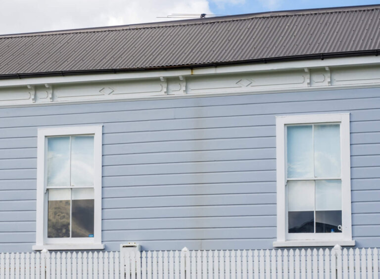 Three windows on timer weatherboard wall