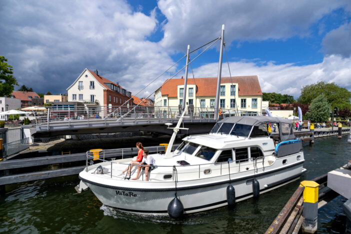 Malchow, Germany - June 8, 2020: motorboat passing the Malchow swing bridge