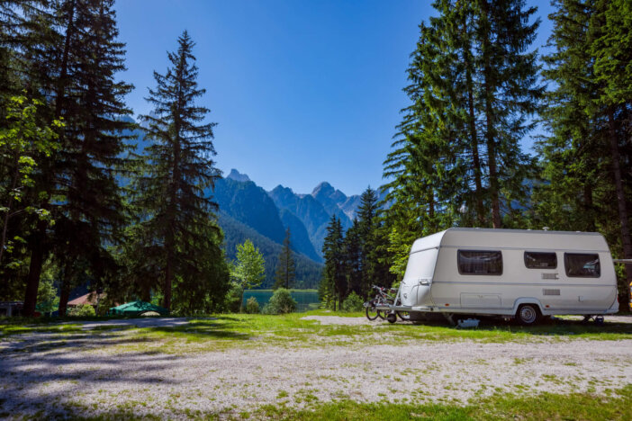 Family vacation travel, holiday trip in motorhome RV, Caravan car Vacation. Beautiful Nature Italy natural landscape Alps.