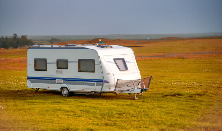 Roulotte on the countryside of Iceland, summer season, white caravan in autumn