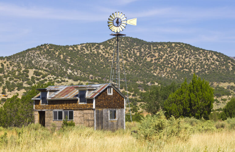 "Old farm with windmill in the ghost town White Oaks, New Mexico, USA."