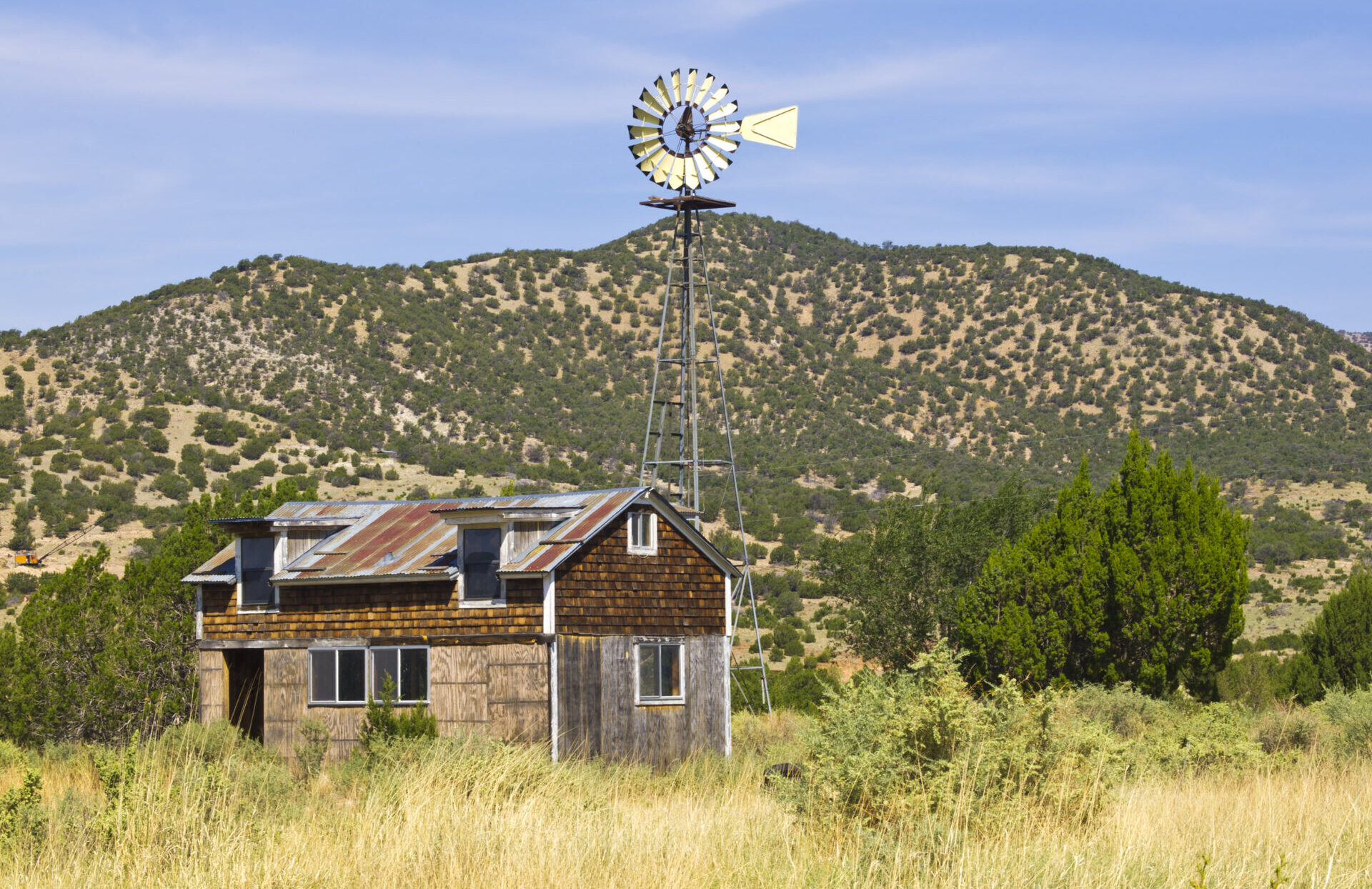 "Old farm with windmill in the ghost town White Oaks, New Mexico, USA."