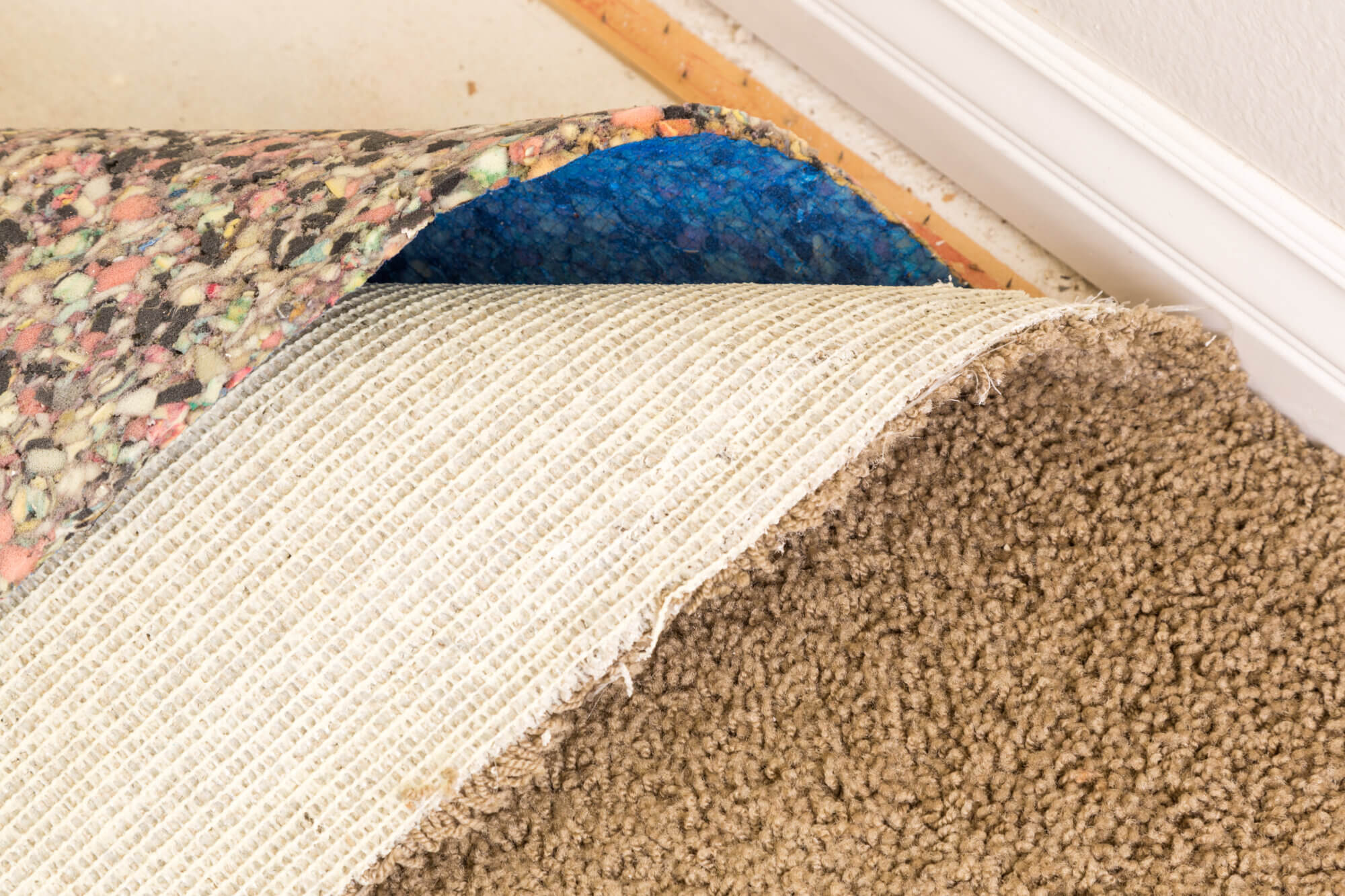 Pulled Back Carpet and Padding In Room of House.