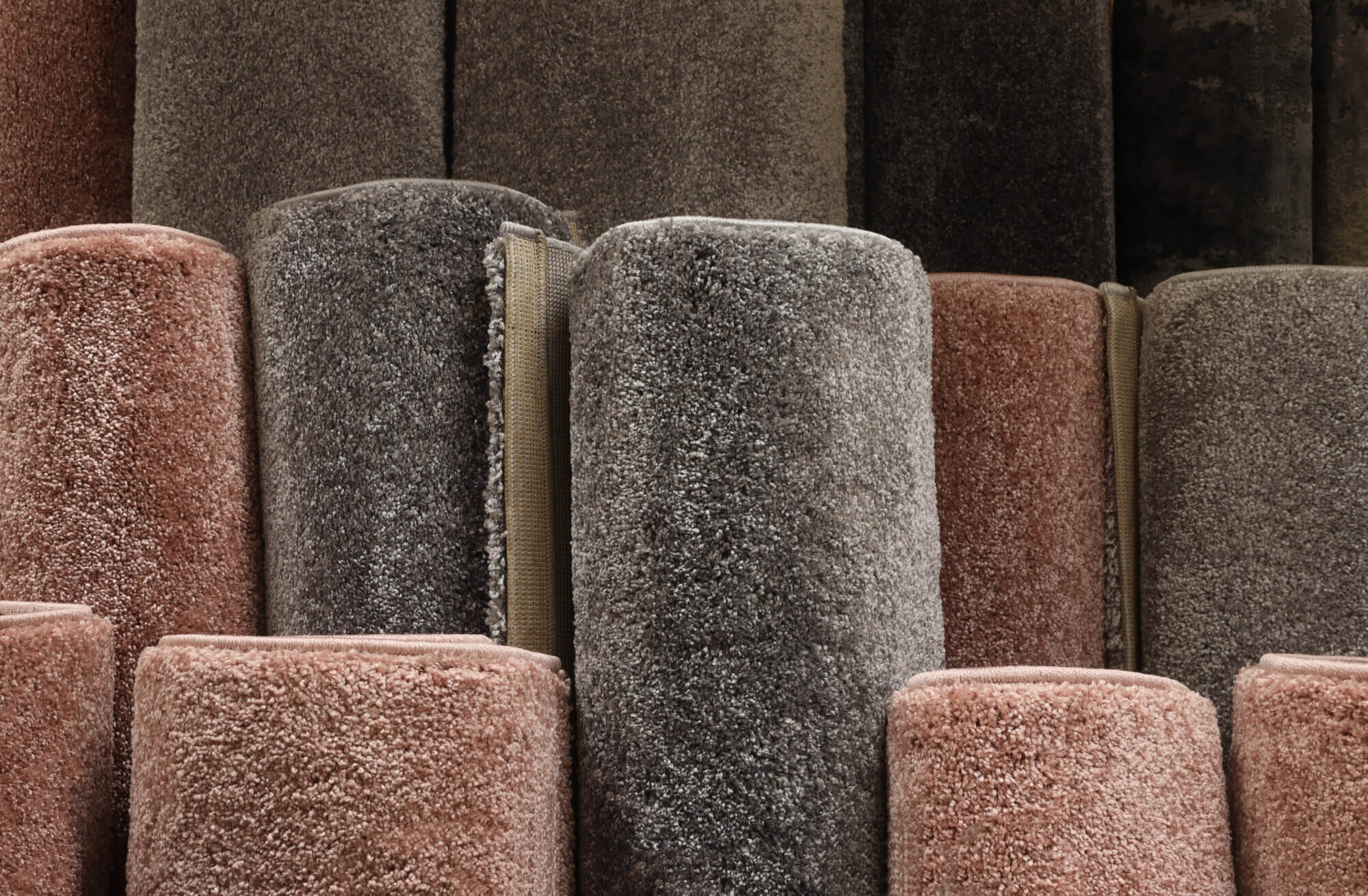 Here are carpets variety selection rolled up rugs shop store lot.