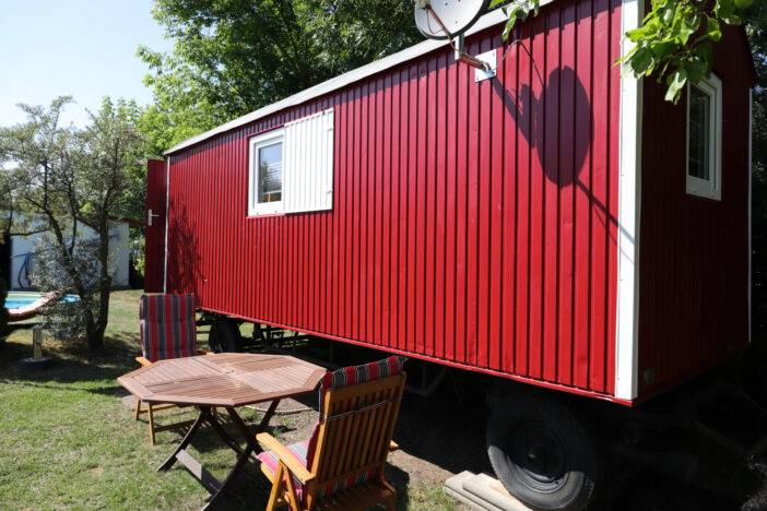a red trailer with chairs and a table