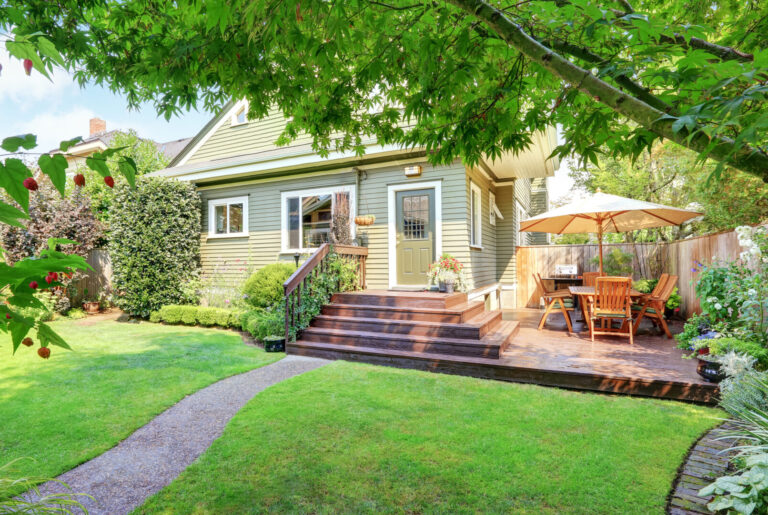 Backyard area with walkout deck, patio table set and well kept lawn. Northwest, USA