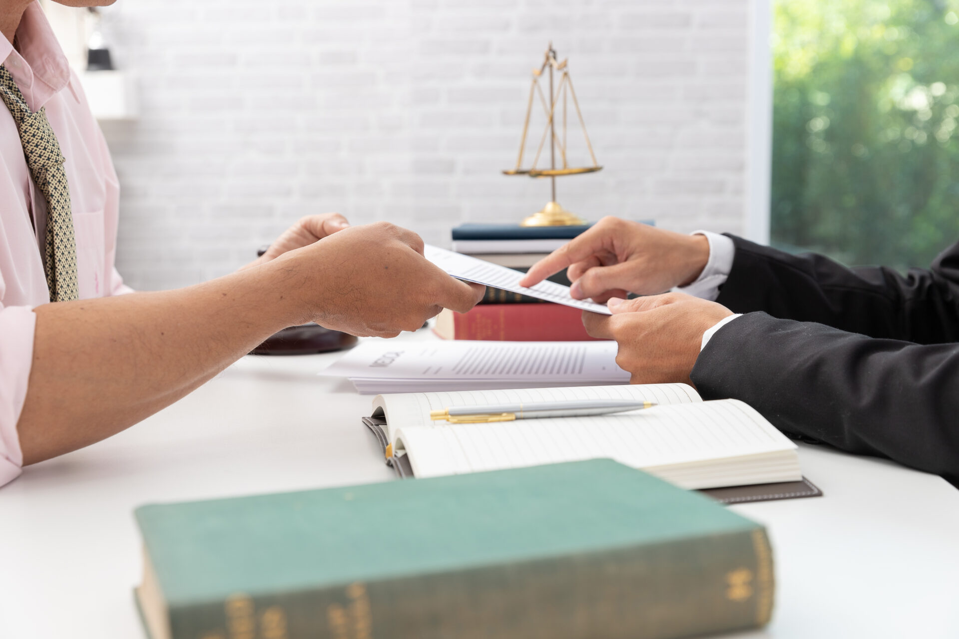 Concepts of law, Lawyer and businessman working and discussing business contract papers in office.