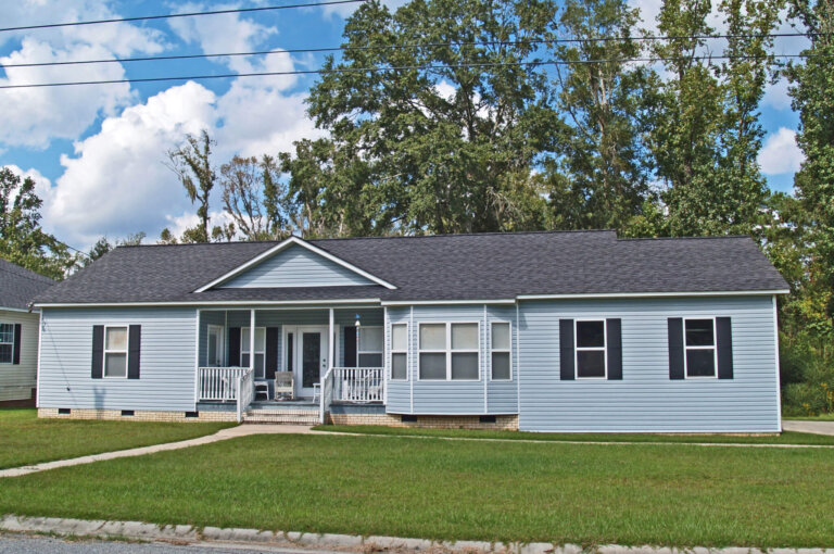 Thomasville, Georgia, USA – October 9, 2009:  Low income single story blue home with siding and black shutters.